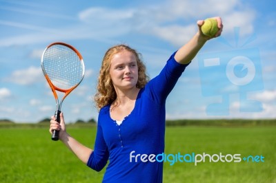 Young Dutch Woman Holding Tennis Racket And Ball Outdoors Stock Photo