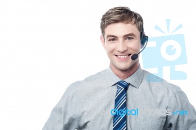 Young Employee Assisting Customer On Call Stock Photo