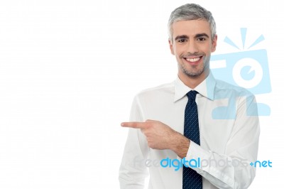 Young Employee Pointing Away Stock Photo