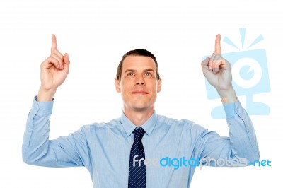 Young Executive Indicating And Looking Upwards Stock Photo