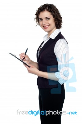 Young Executive Jotting Down Important Notes Stock Photo