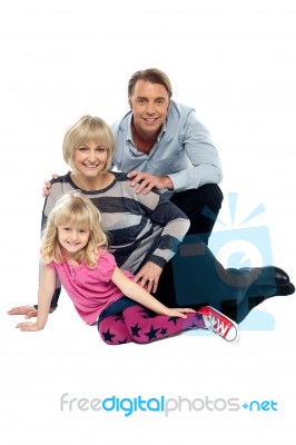 Young Family Of Three Posing Indoors. Studio Shot Stock Photo