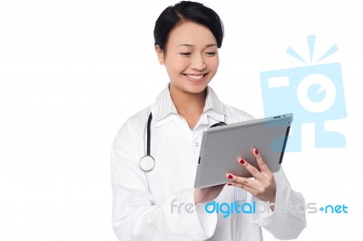 Young Female Doctor Holding A Tablet Stock Photo