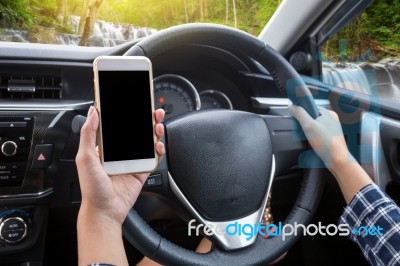 Young Female Driver Using Touch Screen Smartphone And Hand Holdi… Stock Photo