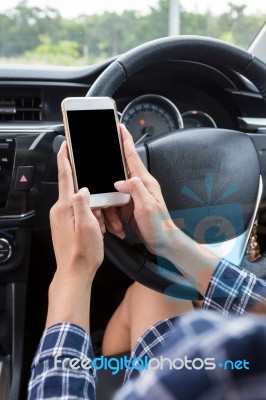 Young Female Driver Using Touch Screen Smartphone In A Car Stock Photo