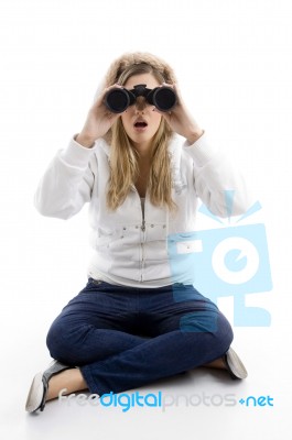 Young Female Watching Into Binoculars Stock Photo