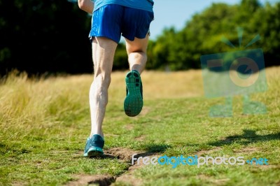 Young Fit Man Running Outdoors Stock Photo