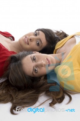 Young Friends Lying On Floor Stock Photo