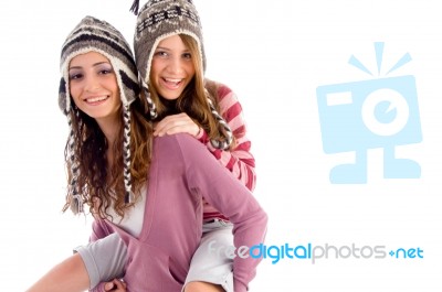 Young Girl Giving Piggyback To Her Friend Stock Photo