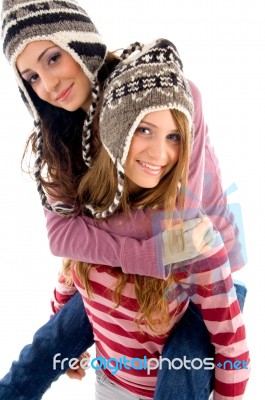 Young Girl Giving Piggyback To Her Friend Stock Photo