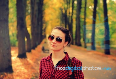 Young Girl In Checkered Shirt In Autumn Park Stock Photo