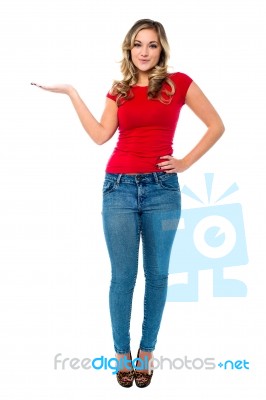 Young Girl In Trendy Wear Presenting Something Stock Photo