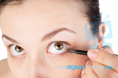 Young Girl Is Doing Her Makeup, Isolated On White Stock Photo