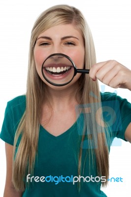 Young Girl Playing Around With Magnifying Glass Stock Photo