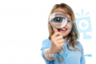 Young Girl Playing Around With Magnifying Glass Stock Photo