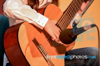 Young Girl Plays Guitar Stock Photo