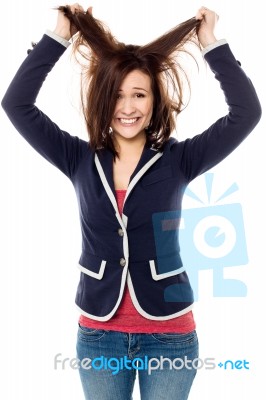 Young Girl Pulling Her Hair In Excitement Stock Photo