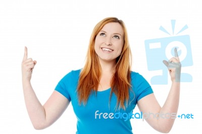 Young Girl Raising Her Arms And Looking Up Stock Photo