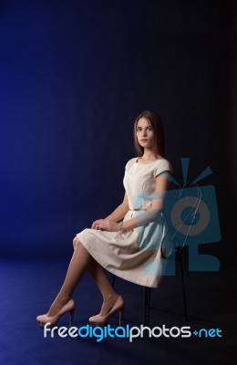 Young Girl Sitting On A Chair Stock Photo