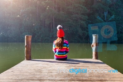 Young Girl Sitting On A Pier Stock Photo