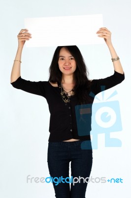 Young Girl Smiling Holding Blank Card Stock Photo