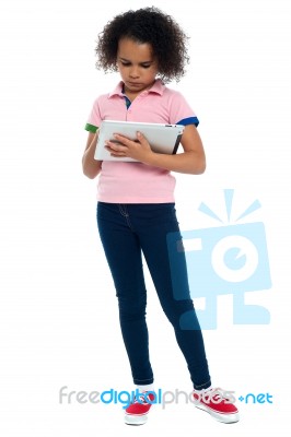 Young Girl Super Busy In Operating New Tablet Device Stock Photo