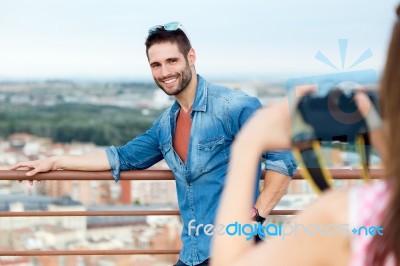 Young Girl Taking Photo Of Her Boyfriend Stock Photo