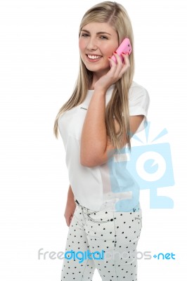 Young Girl Talking To Her Freind Through Cellphone Stock Photo