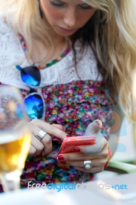 Young Girl Using His Mobile Phone In The Street Stock Photo