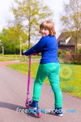 Young Girl With Pink Step Looking Back Stock Photo