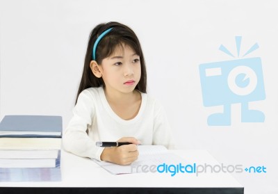 Young Girl Writing Homework Stock Photo