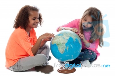 Young Girls Locating Countries On Globe Stock Photo