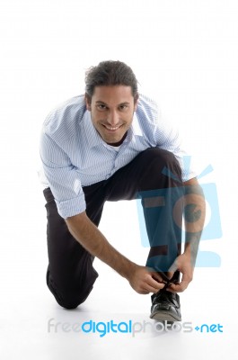 Young Good Looking Man Tying His Shoelace Stock Photo