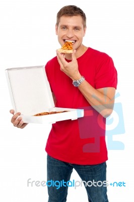 Young Guy Eating Pizza Stock Photo