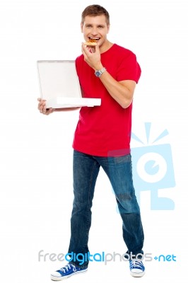 Young Guy Eating Pizza Stock Photo