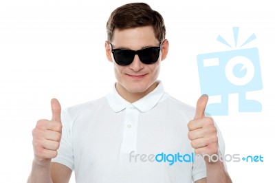 Young Guy Gesturing Thumbs Up Stock Photo