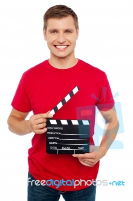 Young Guy Holding Clapperboard Stock Photo