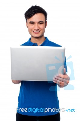 Young Guy Holding Laptop Stock Photo