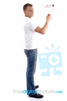 Young Guy Holding Rolling Brush Stock Photo