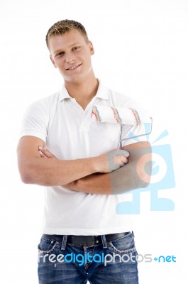 Young Guy Holding Rolling Brush Stock Photo