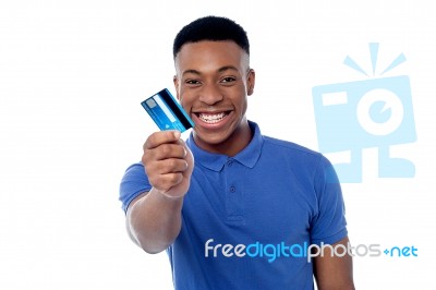 Young Guy Offering Credit Card Stock Photo