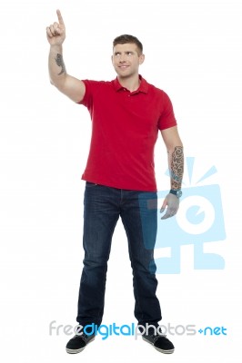 Young Guy Pointing Upwards Stock Photo