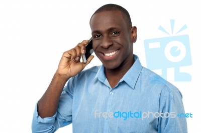 Young Handsome Guy Attending A Phone Call Stock Photo