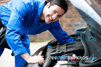 Young Handsome Mechanic Looking At Camera Stock Photo