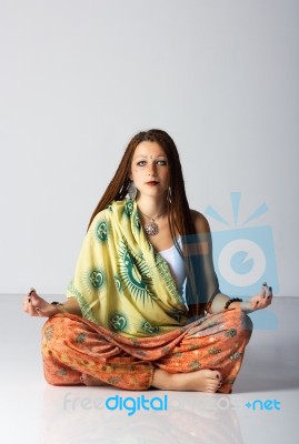 Young Indian Woman Posing Sitting On The Floor Stock Photo