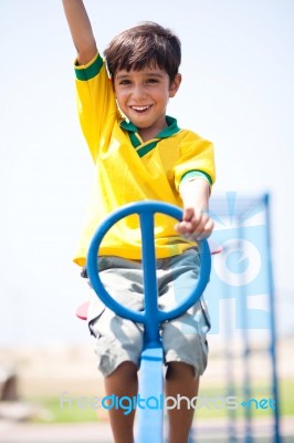 Young Kid Enjoying Swing Ride Stock Photo