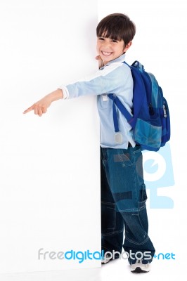 Young Kid Pointing To Empty Space Stock Photo