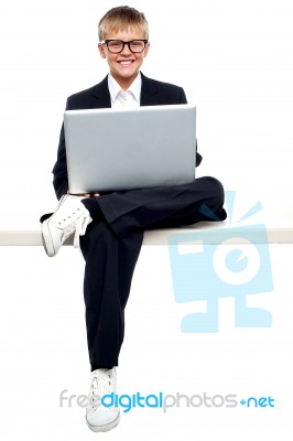 Young Kid Working On Laptop Stock Photo