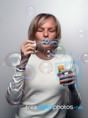 Young Lady Blowing Bubbles Stock Photo