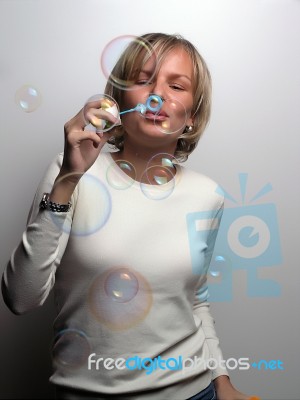 Young Lady Blowing Bubbles Stock Photo